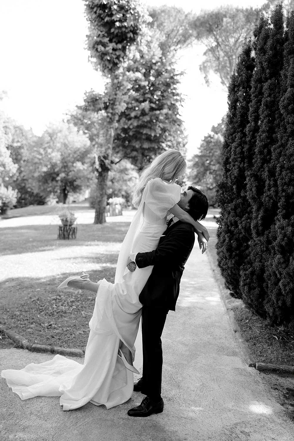 Bride and groom embracing during portraits at their intimate Tuscany wedding.