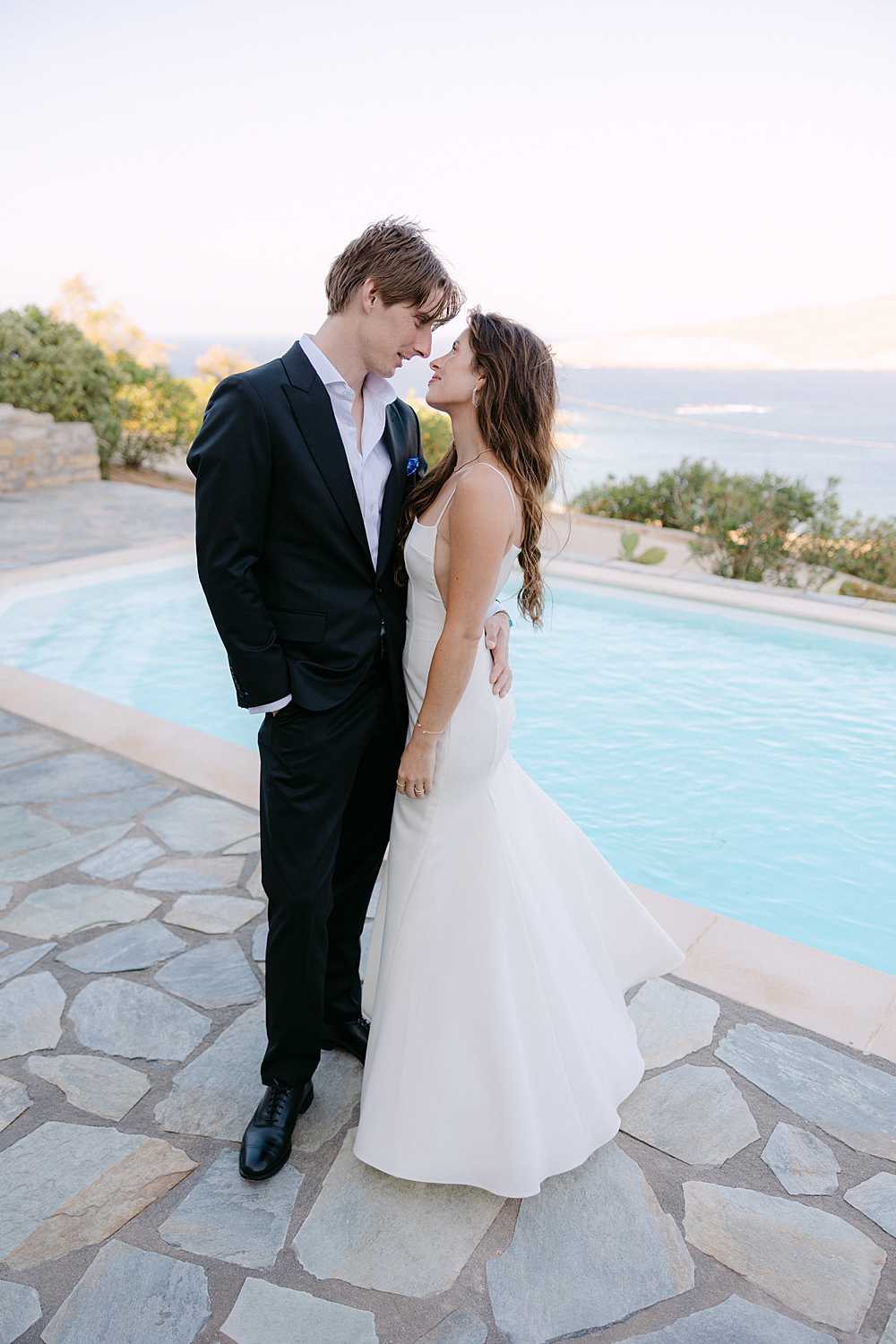 Bride and groom at a private villa wedding in Mykonos overlooking the Aegean Sea.